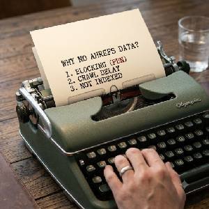 Vintage typewriter on a rustic wooden desk showing typed diagnostic checklist of reasons why backlinks may not show in Ahrefs: BLOCKING (PBN), CRAWL DELAY, NOT INDEXED.